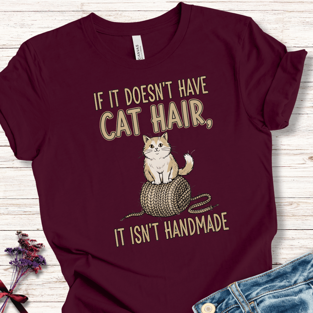 Maroon cat-themed t-shirt with humorous quote and graphic of a cat on yarn.