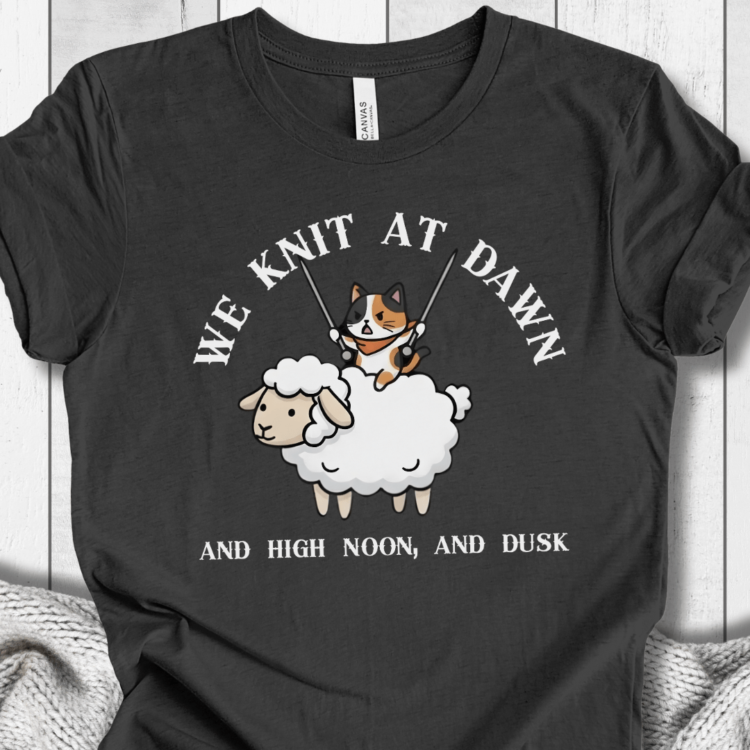 Funny black t-shirt featuring a cat on a sheep with knitting needles, perfect for knitters and animal lovers.