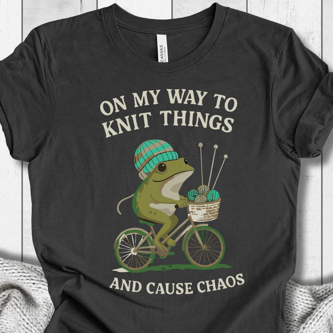 Funny frog on bike graphic t-shirt, charcoal color, perfect for knitting enthusiasts.