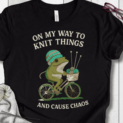 Funny black t-shirt featuring a frog on a bicycle with a knitting theme.
