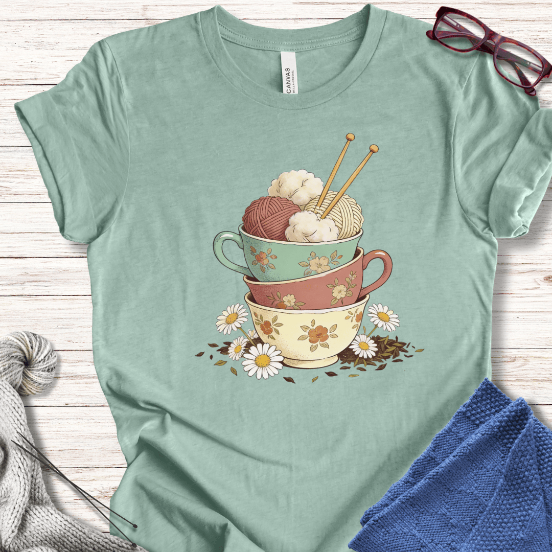 Mint green t-shirt with stacked floral cups and yarn, perfect for crafters and knitters.