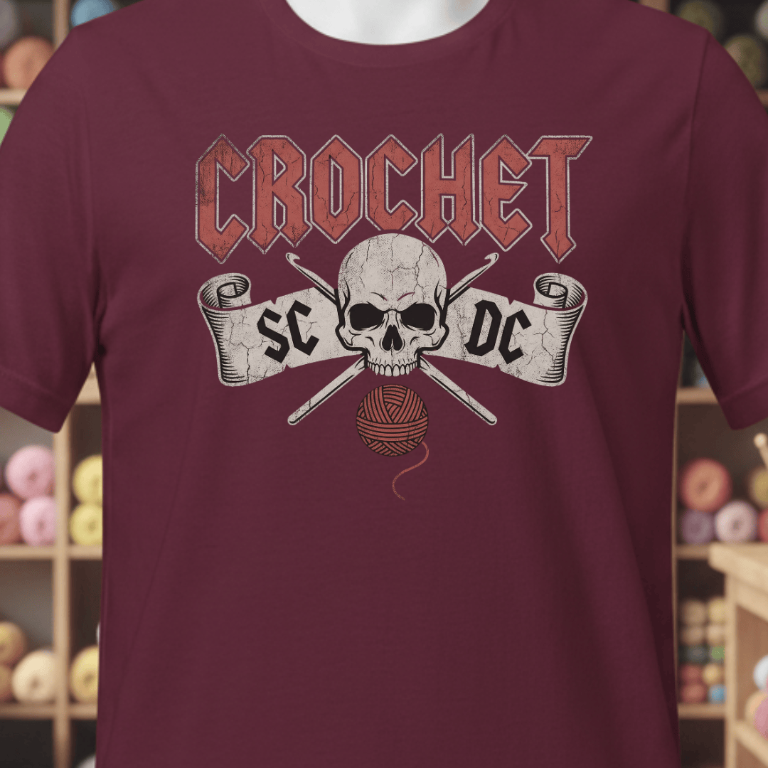 Maroon crochet-themed t-shirt with skull and yarn graphic for yarn enthusiasts.