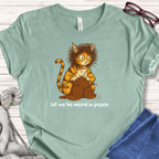 Mint green cat t-shirt featuring a quirky cat knitting, with the text 'let me be weird in peace'.