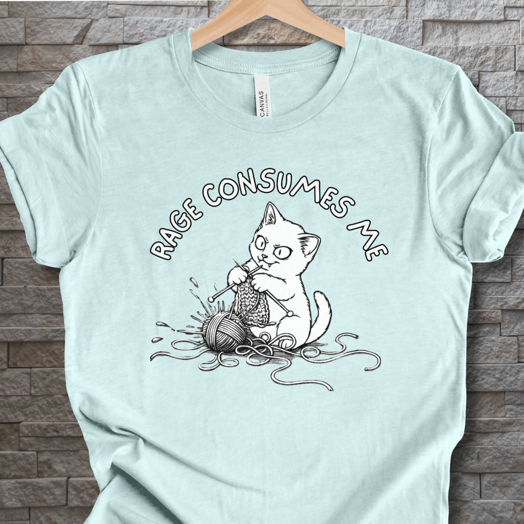 Light blue t-shirt featuring a humorous cat knitting design with the text 'RAGE CONSUMES ME'.