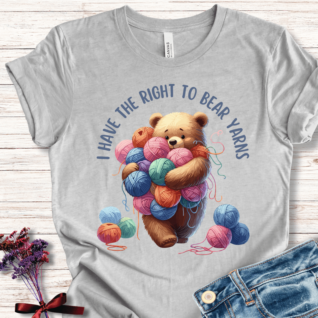 Grey t-shirt featuring a cute bear holding colorful yarn balls with text 'I Have the Right to Bear Yarns'.