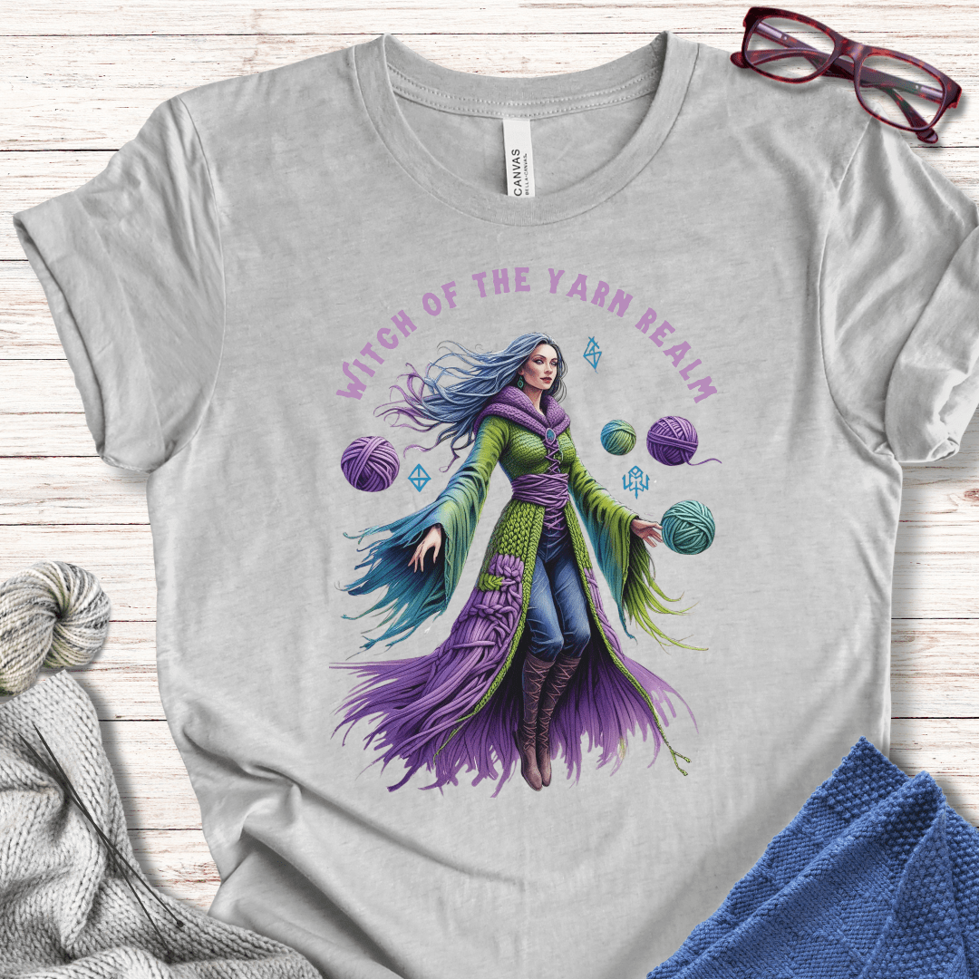 Gray t-shirt featuring 'Witch of the Yarn Realm' graphic design, vibrant colors, and cozy fabric.