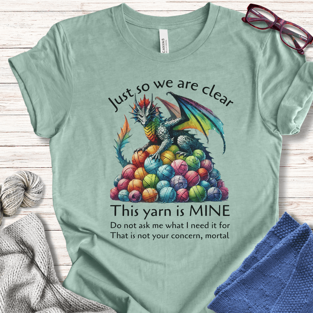 Funny dragon graphic tee in mint green, featuring vibrant yarn balls and humorous text about yarn ownership.