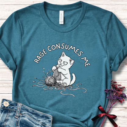 Teal cotton t-shirt featuring a cartoon cat knitting yarn with the text 'RAGE CONSUMES ME'.